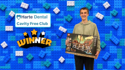 Harte Dental cavity free club winner standing with Lego prize. Accepting new patients in Milton